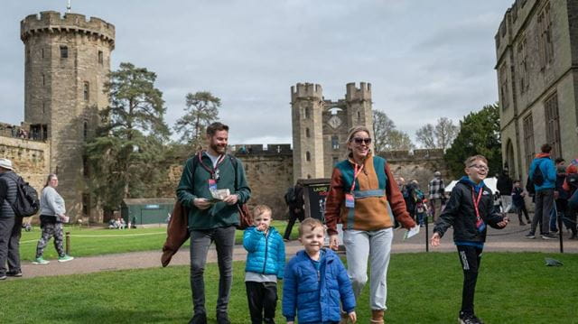 Family walking outside Warwick castle